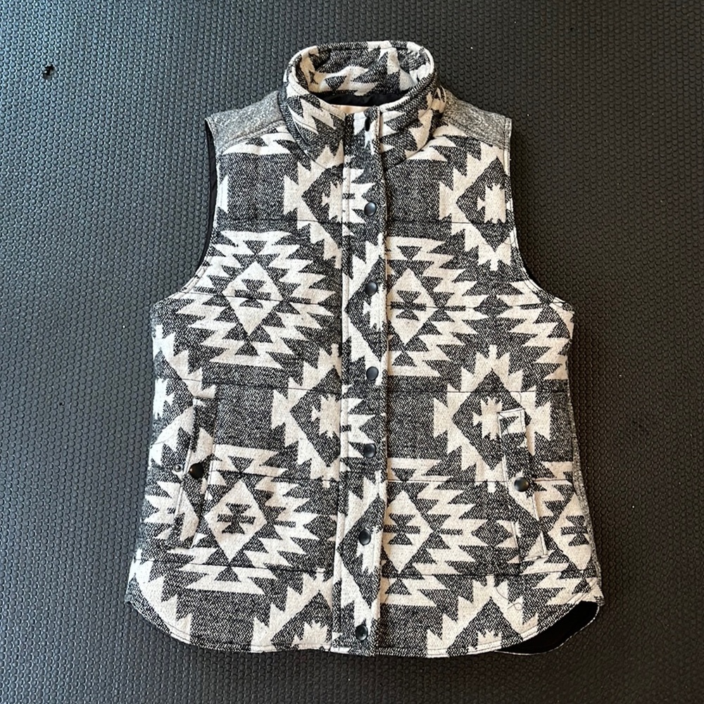 Skies are Blue puffy vest, black, grey, cream pattern.  Size small.